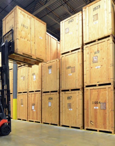 Woman carrying a cardboard box in a warehouse